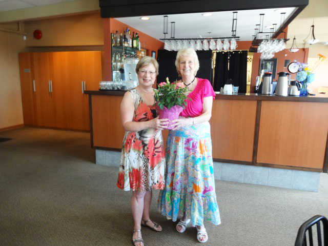 Merilee Baldock receiving plant as a gift for all her hard work for the Gibsons hospital auxiliary from Marilyn Ranniger